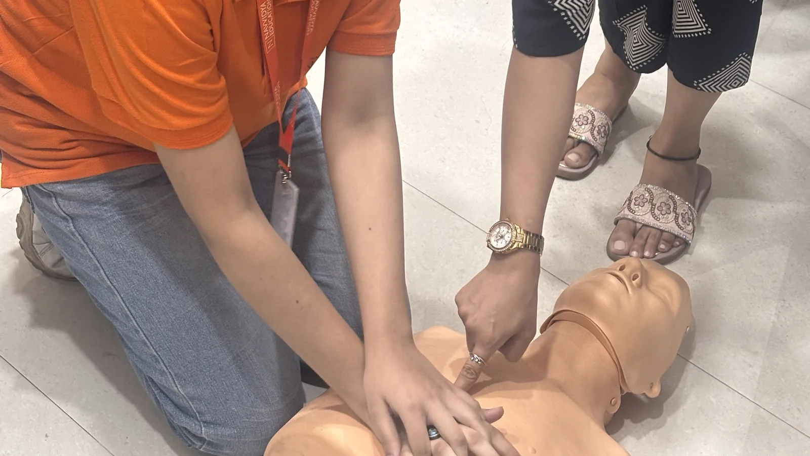 Navvidya students practicing CPR on training manikin